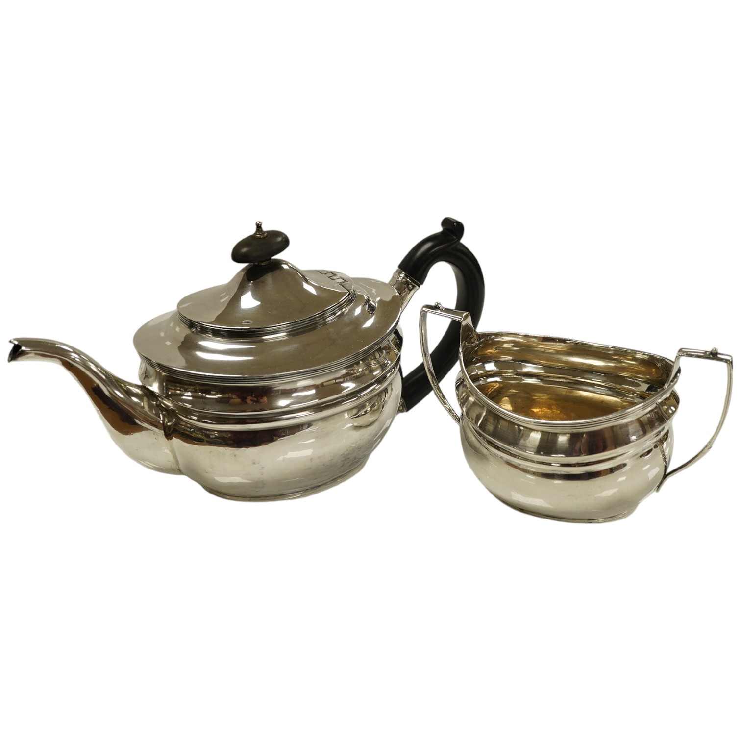 An Edwardian silver teapot and two handled sugar bowl by Charles Stuart Harris & Sons, London 1907, gross weight 23.4oz. Condition - poor to fair